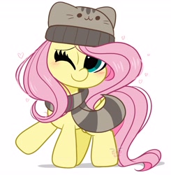 Size: 4012x4096 | Tagged: safe, artist:kittyrosie, derpibooru import, fluttershy, pegasus, pony, blushing, cap, clothes, cute, hat, looking at you, one eye closed, pusheen, scarf, shyabetes, simple background, solo, white background, winter cap