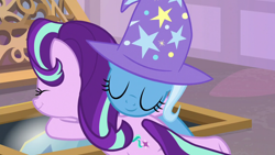 Size: 1920x1080 | Tagged: safe, derpibooru import, screencap, starlight glimmer, trixie, pony, unicorn, the ending of the end, clothes, eyes closed, female, hat, hug, mare, shipping fuel, smiling, trixie's hat