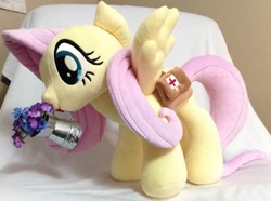 Size: 1185x884 | Tagged: safe, artist:c20710, derpibooru import, fluttershy, pegasus, bag, first aid kit, flower, irl, photo, plushie, saddle bag, solo, spread wings, watering can, wings