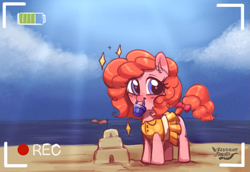 Size: 2615x1802 | Tagged: safe, artist:opossum_imoto, derpibooru import, oc, oc only, oc:peachy keen, earth pony, pony, beach, blushing, clothes, cute, dress, female, filly, happy, looking at you, mouth hold, ocbetes, ocean, proud, recording, sandcastle, signature, smiling, solo, water