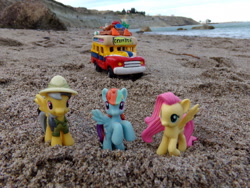 Size: 2048x1536 | Tagged: safe, artist:dingopatagonico, derpibooru import, daring do, fluttershy, rainbow dash, pony, beach, bus, irl, ocean, photo, sand, toy