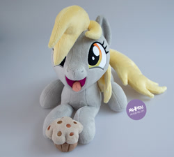 Size: 1400x1259 | Tagged: safe, artist:meplushyou, derpibooru import, derpy hooves, pegasus, pony, food, irl, lying down, muffin, photo, plushie, prone, solo, tongue out
