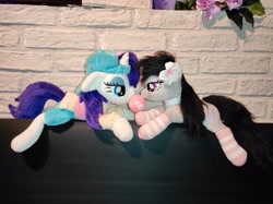 Size: 4640x3472 | Tagged: safe, derpibooru import, octavia melody, rarity, earth pony, pony, unicorn, alternate hairstyle, clothes, disguise, female, flower, flower in hair, lesbian, lying down, photo, plainity, plushie, prone, raritavia, shipping, socks, striped socks