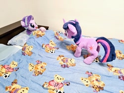 Size: 1024x768 | Tagged: safe, artist:nekokevin, starlight glimmer, twilight sparkle, unicorn twilight, pony, unicorn, series:nekokevin's glimmy, bed, bedsheets, blanket, duo, female, irl, looking at each other, lying down, mare, photo, pillow, plushie, smiling, underhoof