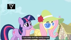 Size: 636x358 | Tagged: safe, derpibooru import, screencap, fluttershy, twilight sparkle, pegasus, pony, unicorn, green isn't your color, duo, duo female, female, hat, mare, sunglasses, youtube caption