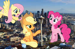 Size: 1600x1042 | Tagged: safe, artist:illumnious, artist:logan859, artist:luckreza8, artist:vladimirmacholzraum, applejack, fluttershy, pinkie pie, earth pony, pegasus, pony, city, giant pony, highrise ponies, irl, macro, photo, ponies in real life, seattle, washington