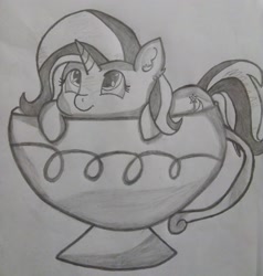 Size: 2448x2574 | Tagged: safe, artist:dashybestpony, trixie, pony, unicorn, cup, cup of pony, cute, female, lying, mare, micro, monochrome, simple background, smiling, solo, teacup, that pony sure does love teacups, traditional art