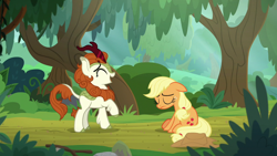 Size: 1280x720 | Tagged: safe, derpibooru import, screencap, applejack, autumn blaze, earth pony, kirin, pony, sounds of silence, duo, eyes closed, female, floppy ears, forest, laughing, mare, raised hoof, sitting