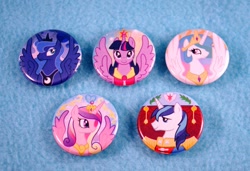 Size: 907x622 | Tagged: safe, princess cadance, princess celestia, princess luna, shining armor, twilight sparkle, twilight sparkle (alicorn), alicorn, pony, unicorn, button, female, mare, merchandise