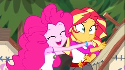 Size: 1100x618 | Tagged: safe, screencap, pinkie pie, sunset shimmer, equestria girls, legend of everfree, bracelet, camp everfree outfits, incoming hug, jewelry, sun, tree