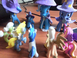 Size: 640x480 | Tagged: safe, derpibooru import, gilda, granny smith, princess cadance, shining armor, surprise, trixie, griffon, pony, unicorn, blind bag, irl, multeity, photo, toy, trixie army, trixie's cape, trixie's hat, wonderbolts