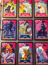 Size: 1936x2592 | Tagged: safe, derpibooru import, carrot top, daring do, discord, gilda, golden harvest, lyra heartstrings, mare do well, nightmare moon, prince blueblood, queen chrysalis, steven magnet, trixie, changeling, changeling queen, griffon, pony, card, irl, merchandise, photo, trading card