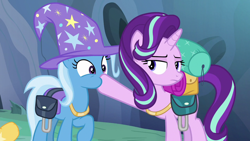 Size: 1280x720 | Tagged: safe, derpibooru import, screencap, starlight glimmer, trixie, pony, to where and back again, hoof in mouth, jewelry, necklace, saddle bag, trixie's hat