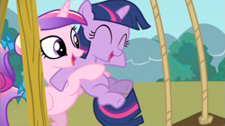 Size: 853x480 | Tagged: safe, screencap, princess cadance, twilight sparkle, alicorn, pony, a canterlot wedding, duo, eyes closed, female, filly, filly twilight sparkle, foalsitter, holding a pony, swing, swing set, teen princess cadance, younger