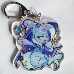 Size: 712x712 | Tagged: safe, artist:mococo, derpibooru import, trixie, pony, unicorn, female, keychain, lidded eyes, mare, smug, solo, trixie's cape, trixie's hat