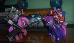 Size: 900x523 | Tagged: safe, derpibooru import, pinkie pie, twilight sparkle, burger king toys, fight, fusion cannon, irl, megatron, optimus prime, photo, prime (transformers), riding, toy, toy pony cavalry, transformers