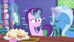 Size: 1280x720 | Tagged: safe, derpibooru import, screencap, starlight glimmer, trixie, pony, unicorn, all bottled up, cup, discovery family logo, eyes closed, floppy ears, food, icing bag, levitation, magic, open mouth, raised eyebrow, smiling, teacakes, teacup, telekinesis