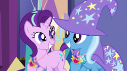 Size: 1280x720 | Tagged: safe, derpibooru import, screencap, starlight glimmer, trixie, pony, unicorn, celestial advice, cute, diatrixes, equestrian pink heart of courage, eye contact, female, glimmerbetes, grin, hoof hold, jewelry, looking at each other, mare, necklace, smiling, squee