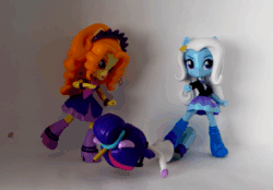 Size: 525x365 | Tagged: safe, artist:whatthehell!?, derpibooru import, edit, adagio dazzle, sci-twi, sunset shimmer, trixie, twilight sparkle, equestria girls, abuse, animated, boots, bully, bullying, clothes, coat, doll, equestria girls minis, glasses, irl, jewelry, justice, kicking, pencil, photo, protecting, scitwibuse, shoes, stop motion, sunset sushi, toy, twilybuse