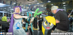 Size: 2048x977 | Tagged: artist needed, safe, artist:unkcos22, derpibooru import, derpy hooves, trixie, human, anime central, anime central 2013, clothes, convention, cosplay, crossover, gloves, hatsune miku, irl, irl human, leek, photo, shield, vocaloid, wand