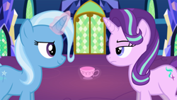 Size: 1920x1080 | Tagged: safe, artist:agrol, derpibooru import, starlight glimmer, trixie, pony, unicorn, cup, female, glowing horn, looking at each other, magic lessons, mare, smiling, teacup, unamused