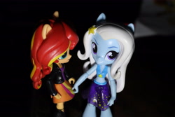 Size: 6000x4000 | Tagged: safe, artist:artofmagicpoland, derpibooru import, sunset shimmer, trixie, equestria girls, equestria girls series, clothes, doll, equestria girls minis, female, lesbian, looking at you, shipping, skirt, skirt pull, suntrix, swimsuit, toy