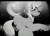 Size: 1233x900 | Tagged: safe, artist:styroponyworks, derpibooru import, trixie, pony, black and white, female, grayscale, grin, looking at you, lying, monochrome, smiling, underhoof