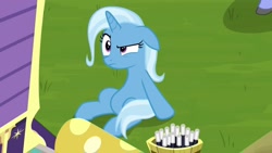 Size: 1280x720 | Tagged: safe, derpibooru import, screencap, hoo'far, trixie, pony, unicorn, road to friendship, annoyed, female, floppy ears, mare, sitting, solo, trixie's wagon