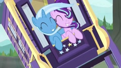 Size: 1280x720 | Tagged: safe, derpibooru import, screencap, starlight glimmer, trixie, pony, unicorn, road to friendship, duo, duo female, eyes closed, female, hug, mare, smiling, trixie's wagon