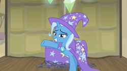 Size: 1255x706 | Tagged: safe, derpibooru import, screencap, trixie, pony, unicorn, road to friendship, cape, chest, clothes, female, grin, hat, mare, raised hoof, smiling, solo, stage, trixie's cape, trixie's hat