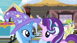 Size: 1920x1080 | Tagged: safe, derpibooru import, screencap, silverstream, starlight glimmer, trixie, pony, unicorn, best gift ever, best friends, clothes, cute, duo focus, earmuffs, female, hat, looking at each other, mare, train station, trixie's hat, wizard hat