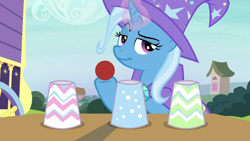 Size: 1280x720 | Tagged: safe, derpibooru import, screencap, trixie, pony, uncommon bond, ball, cup, glowing horn, hoof hold, lidded eyes, magic trick, smiling, smirk, solo