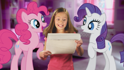 Size: 853x480 | Tagged: safe, screencap, pinkie pie, rarity, human, pony, commercial, exploitable, irl, official, photo, ponies in real life, reaction, scroll, youtube link