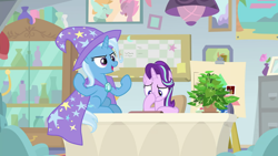 Size: 1920x1080 | Tagged: safe, derpibooru import, screencap, phyllis, starlight glimmer, trixie, pony, unicorn, a horse shoe-in, cape, clothes, duo, female, hat, mare, potted plant, table, trixie's cape, trixie's hat
