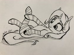 Size: 4032x3024 | Tagged: safe, artist:galinn-arts, derpibooru import, trixie, pony, unicorn, clothes, cute, female, lying down, mare, monochrome, on back, smiling, socks, solo, striped socks, traditional art