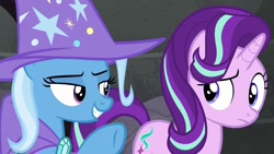 Size: 1280x720 | Tagged: safe, derpibooru import, screencap, starlight glimmer, trixie, pony, unicorn, to where and back again, cape, clothes, duo, duo female, female, hat, mare, trixie's cape, trixie's hat