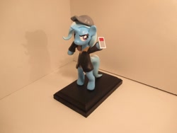 Size: 1024x768 | Tagged: source needed, safe, artist:earthenpony, derpibooru import, trixie, bipedal, cap, clothes, female, figurine, hat, hoof hold, jacket, mare, solo