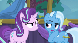 Size: 1008x565 | Tagged: safe, derpibooru import, screencap, starlight glimmer, trixie, pony, unicorn, no second prances, counterparts, discovery family logo, female, mare, raised eyebrow, raised hoof, twilight's counterparts, whispering