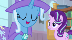 Size: 1920x1080 | Tagged: safe, derpibooru import, screencap, starlight glimmer, trixie, pony, unicorn, a horse shoe-in, cape, clothes, duo, eyes closed, female, hat, mare, trixie's cape, trixie's hat