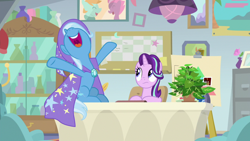 Size: 1920x1080 | Tagged: safe, derpibooru import, screencap, phyllis, starlight glimmer, trixie, pony, unicorn, a horse shoe-in, cape, clothes, desk, duo, female, hat, hooves in air, mare, nose in the air, open mouth, philodendron, plant, potted plant, spreading, trixie's cape, trixie's hat
