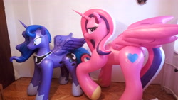 Size: 5632x3168 | Tagged: safe, princess cadance, princess luna, absurd resolution, bedroom eyes, bootleg, eyeshadow, hongyi, horseshoes, inflatable, irl, jewelry, looking back, makeup, necklace, photo