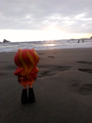 Size: 1944x2592 | Tagged: safe, sunset shimmer, human, equestria girls, beach, clothes, doll, equestria girls minis, eqventures of the minis, irl, irl human, ocean, photo, pun, sand, skirt, sunset, toy, visual pun