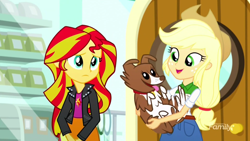 Size: 1280x720 | Tagged: safe, screencap, applejack, sunset shimmer, winona, eqg summertime shorts, equestria girls, pet project, clothes, cowboy hat, happy, hat, jacket, sad, smiling