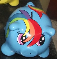 Size: 941x980 | Tagged: safe, derpibooru import, rainbow dash, pegasus, pony, blue coat, female, mare, multicolored mane, piggy bank, sculpture