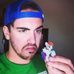 Size: 500x500 | Tagged: safe, rainbow dash, human, blind bag, brony, irl, irl human, photo, solo, toy, unimpressed