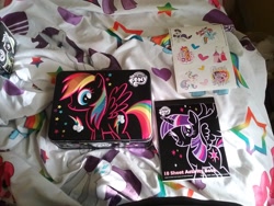 Size: 2592x1944 | Tagged: safe, derpibooru import, apple bloom, daring do, pinkie pie, princess celestia, rainbow dash, rarity, scootaloo, sweetie belle, twilight sparkle, twilight sparkle (alicorn), alicorn, pony, activity book, bedsheets, cloud, female, flower, funko mystery minis, heart, irl, mare, merchandise, photo, stars, sticker, tin box