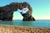 Size: 4310x2868 | Tagged: safe, artist:uponia, artist:yetioner, derpibooru import, rainbow dash, absurd resolution, angry, arch, beach, durdle door, england, flying, irl, limestone, photo, ponies in real life, rock, solo, vector, water