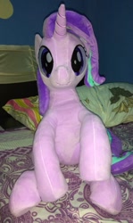 Size: 714x1200 | Tagged: safe, artist:nekokevin, starlight glimmer, pony, unicorn, series:nekokevin's glimmy, bed, female, irl, looking at you, mare, photo, pillow, plushie, raised hoof, sitting, smiling, solo