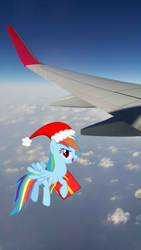 Size: 2988x5312 | Tagged: safe, artist:livehotsun, derpibooru import, rainbow dash, hat, irl, photo, plane, ponies in real life, present, santa hat, sky, solo, vector