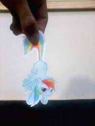 Size: 1200x1600 | Tagged: dead source, safe, artist:ravenarkk, derpibooru import, rainbow dash, human, grumpy, hand, hung upside down, irl, irl human, paper child, paper doll, photo, ponies in real life, tail pull, traditional art, upside down
